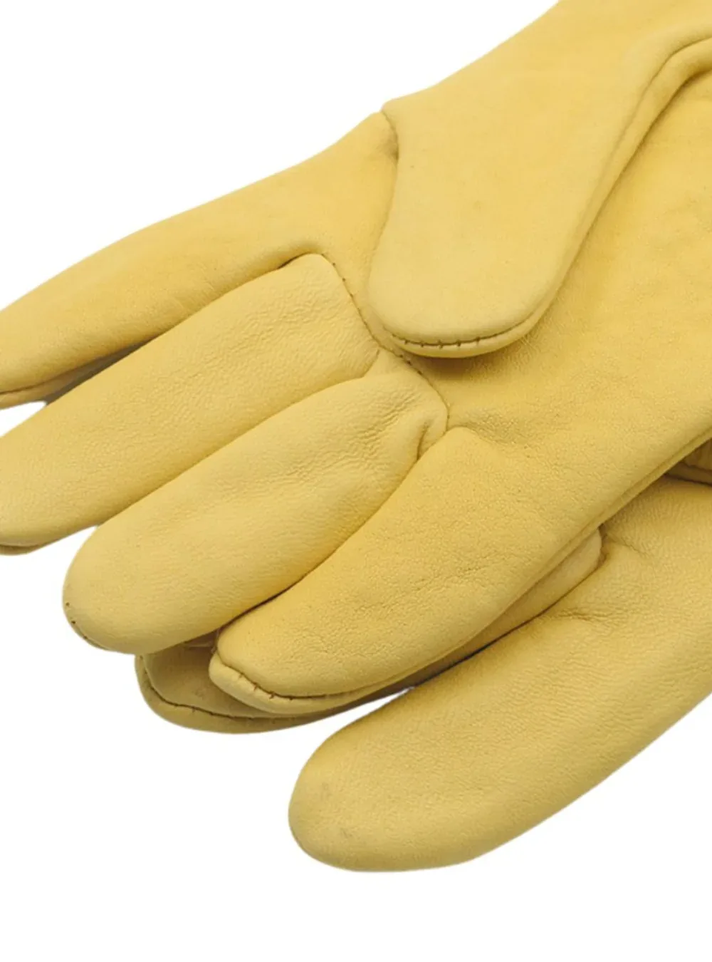 Close-up of yellow leather glove fingertips showing the grain and stitching