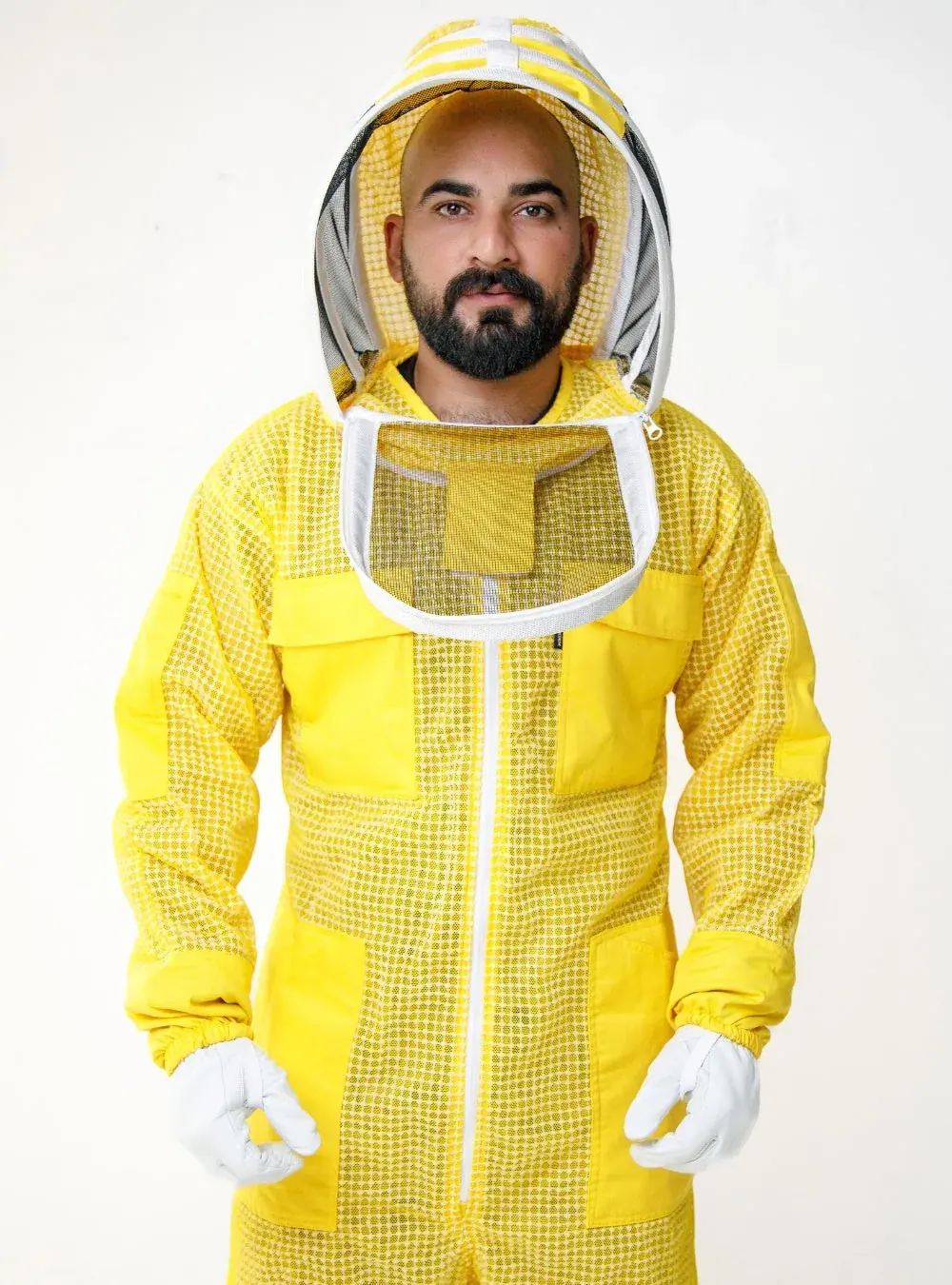 Front view of a beekeeper in a yellow ventilated bee suit with the fencing veil zipped on and gloves over the sleeves