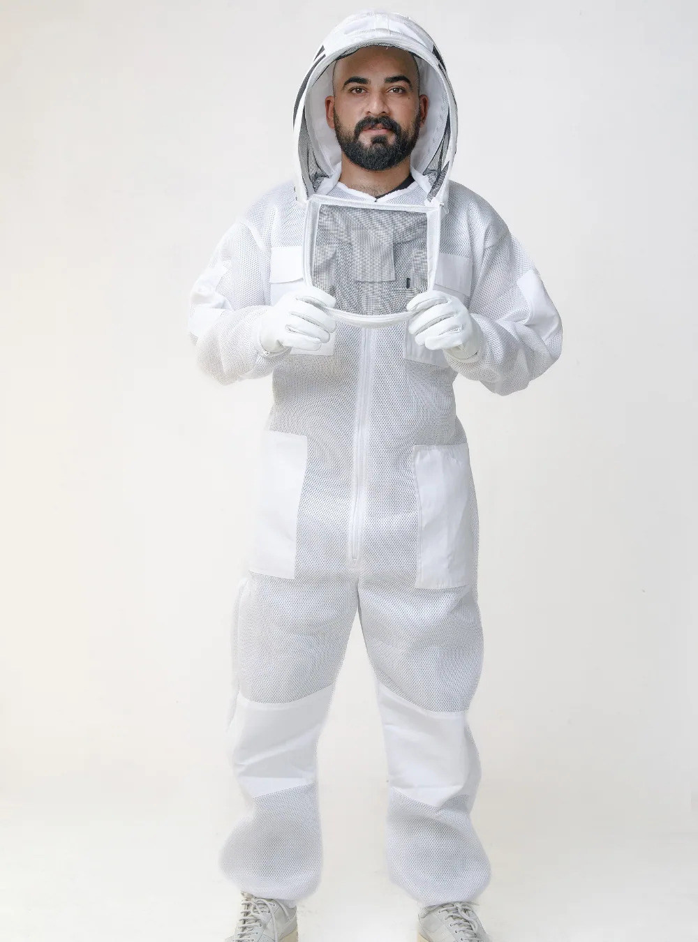 A beekeeper wearing a full ventilated bee suit with the veil attached