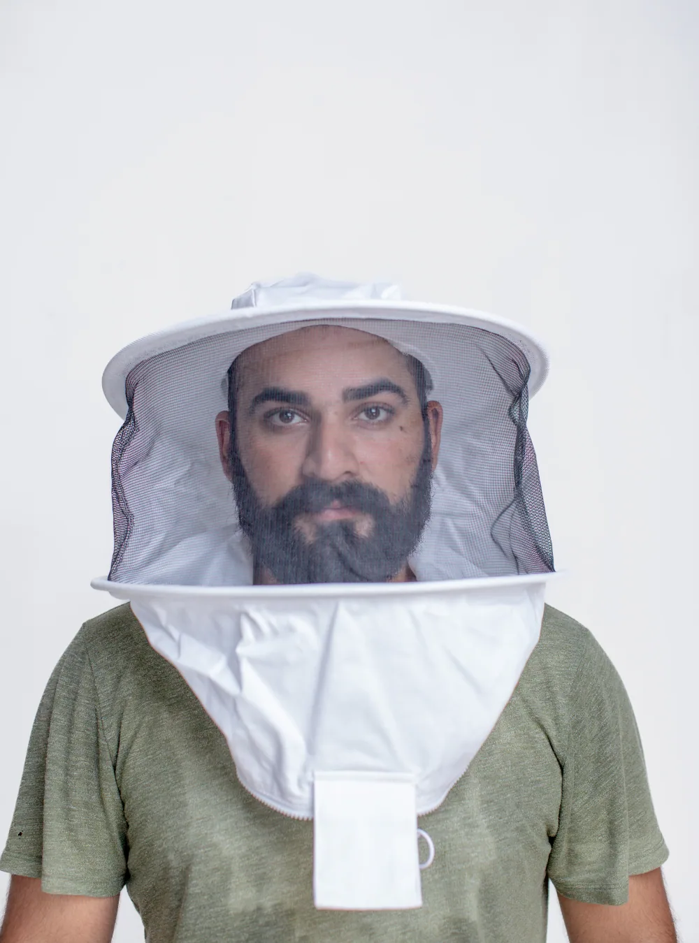 A beekeeping veil held clear of the face, the spacing that prevents veil fogging