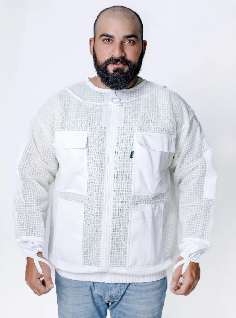 A beekeeping jacket worn with trousers as a two-piece set